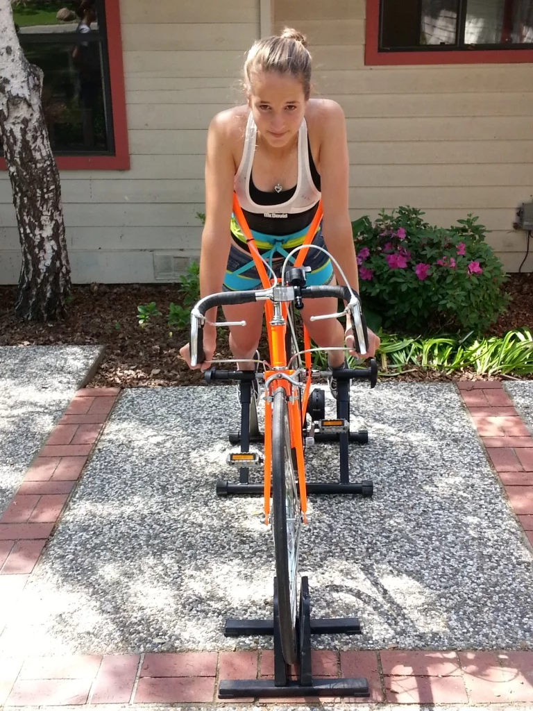 When the rider goes to hammer on the pedals in a sprint or a climb, their back meets a sort of "cage" that holds them down