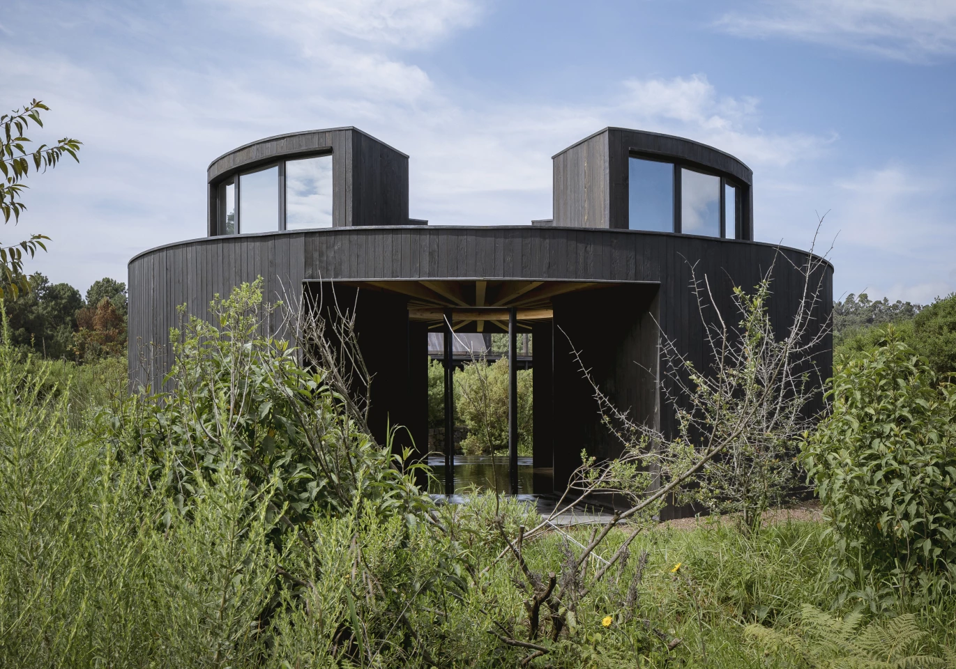 Casa de Baño is located west of Mexico City and is part of a larger off-grid settlement. It's fed by a rainwater harvesting system and includes a hot bath, sauna, steam shower, and washroom organized around a central cold plunge pool that's open to the sky