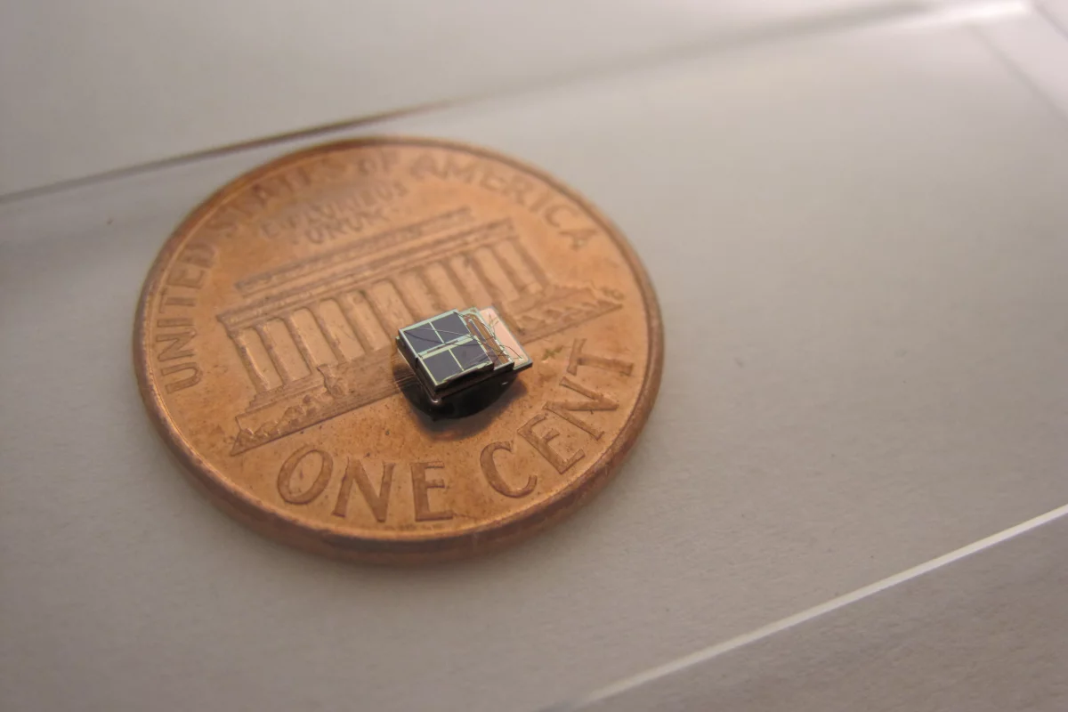 A low-power sensor system developed at the University of Michigan is 1,000 times smaller than comparable commercial counterparts. It could enable new biomedical implants. Photo (Daeyeon Kim)