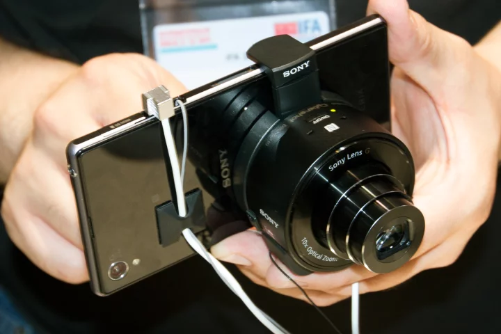 The QX100 is one of two new add-on cameras that can be mounted on mobile devices, such as the new Xperia Z1