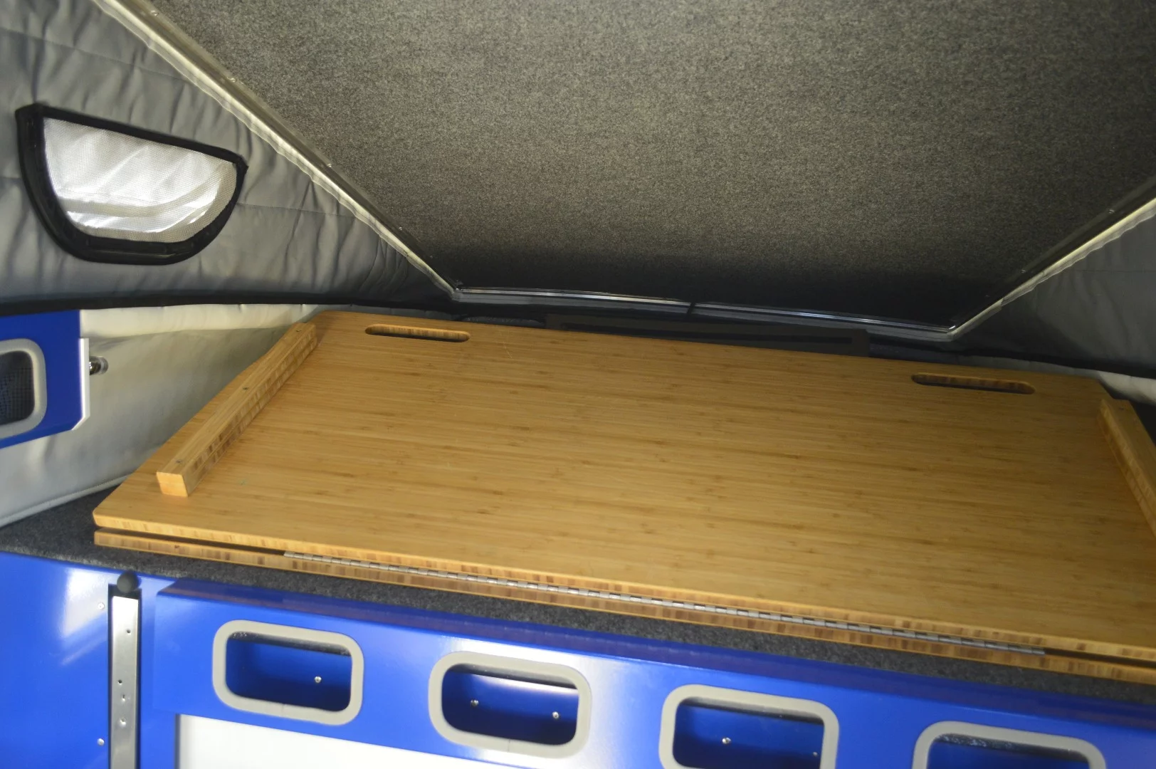 The cabover bed platform folds out of the way to free up the dinette set