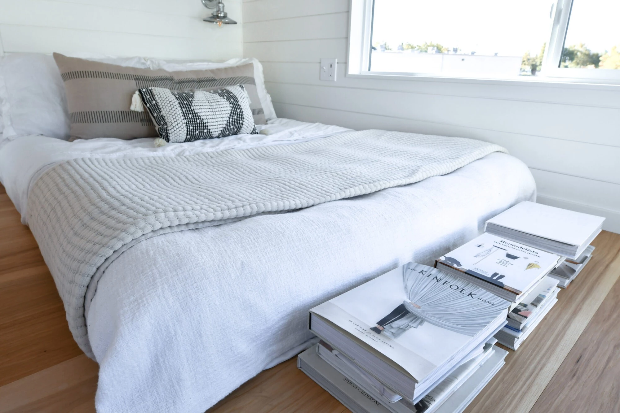 The Urban Park Studio's bedroom includes a double bed, a storage unit, and a bedside table