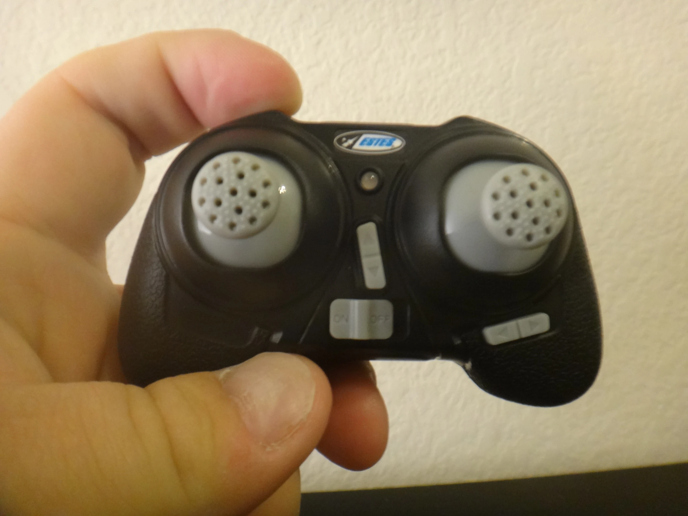 The included radio transmitter looks vaguely like a shrunken video game controller