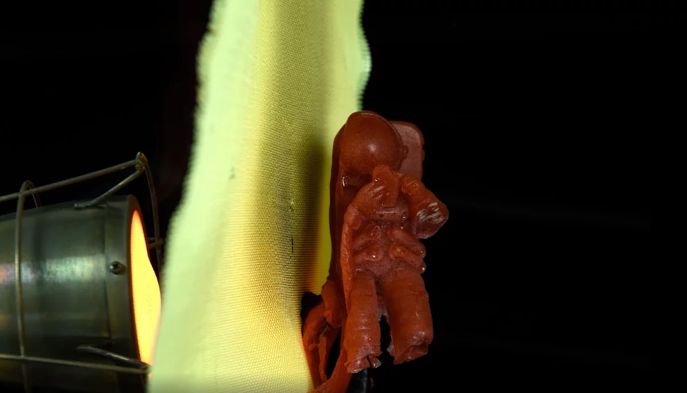 A gelatin astronaut melts when exposed to a flame and protected only by Twaron