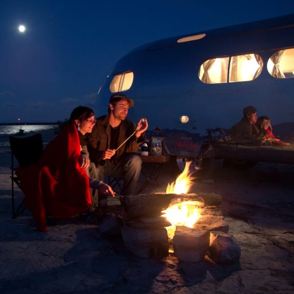 The Bowlus Road Chief features an enclosed undercarriage and flush elliptical windows complete with brass mesh