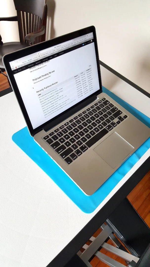 A rubber mat comes with the Edge Desk to keep laptops from sliding around – or off – the hard-plastic surface