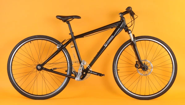 The Stringbike features a symmetric alternating drive system where rope is wrapped around rear wheel drum at one end and a triangular-shaped swinging arm at the pedal end