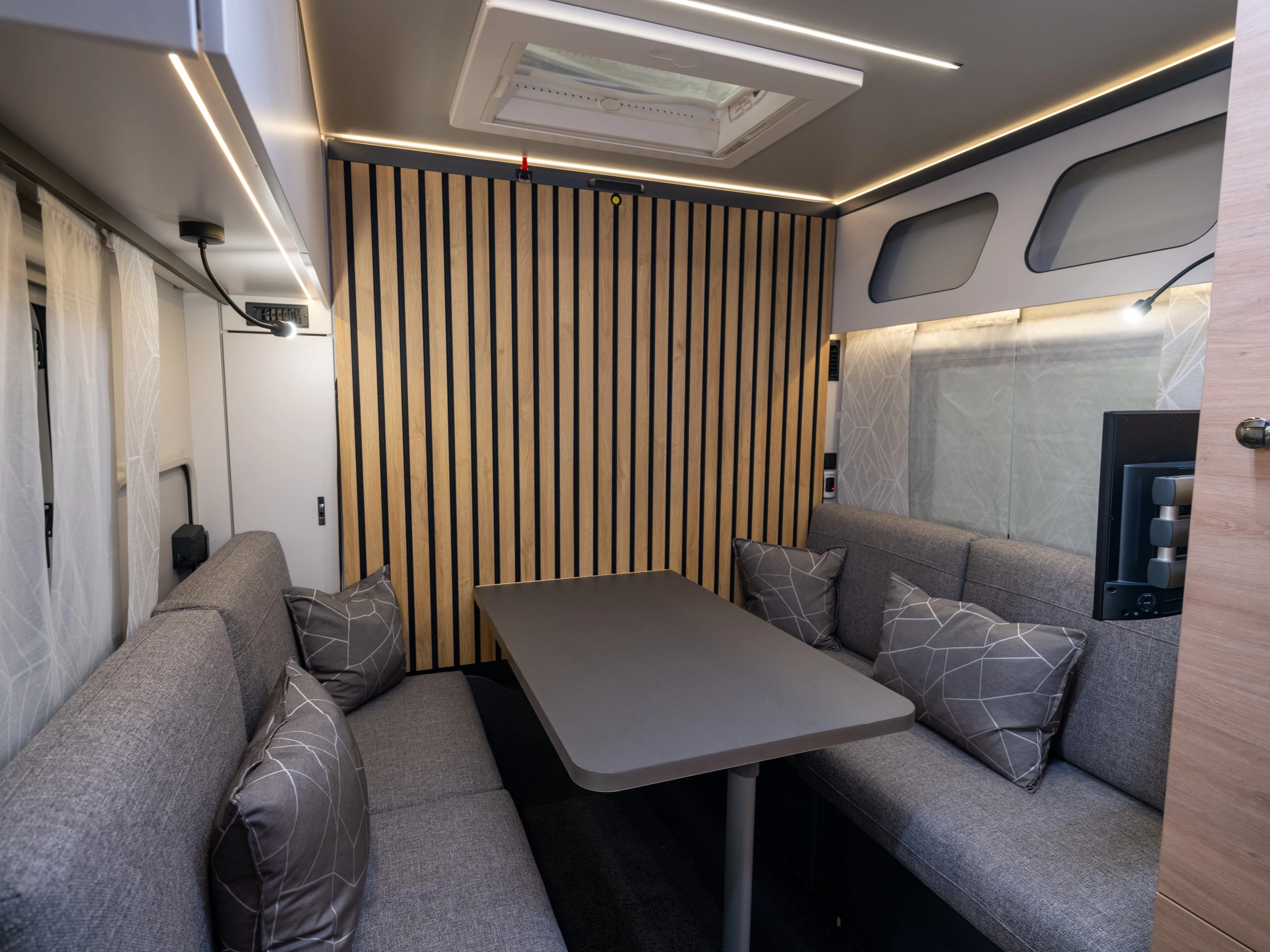 The unassuming dining lounge is ready for mealtime but can quickly transform into the bedroom