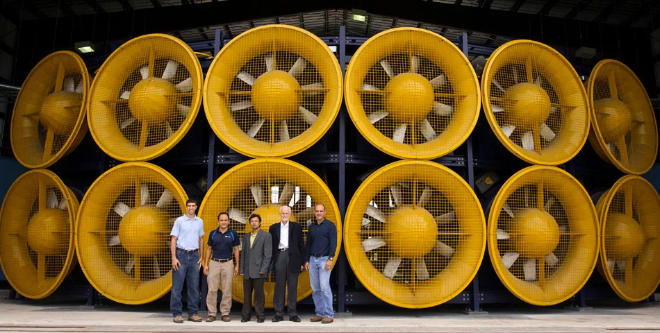 FIU's wind engineering team poses in front of the Wall of Wind