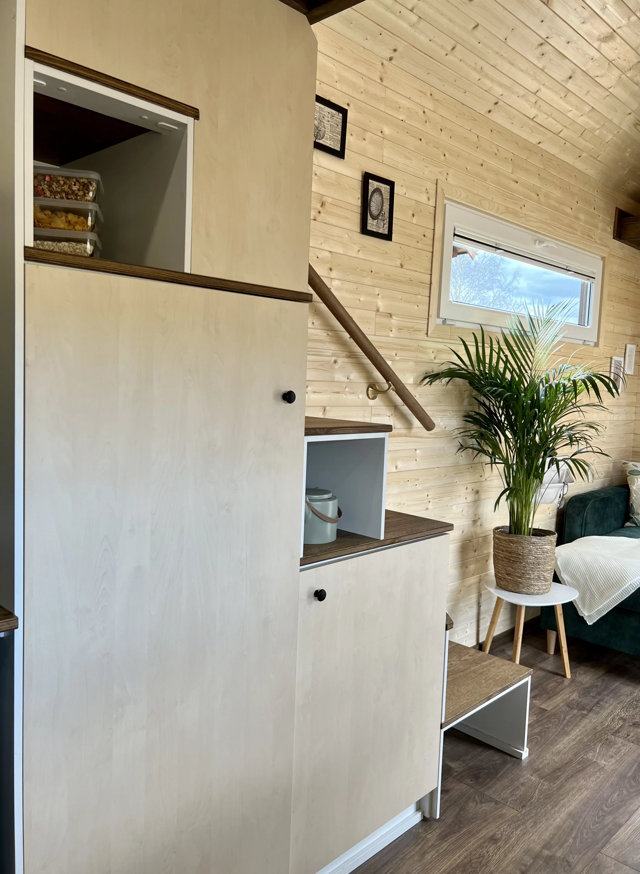The Sunshine tiny house includes a storage-integrated staircase, which provides access to its only bedroom
