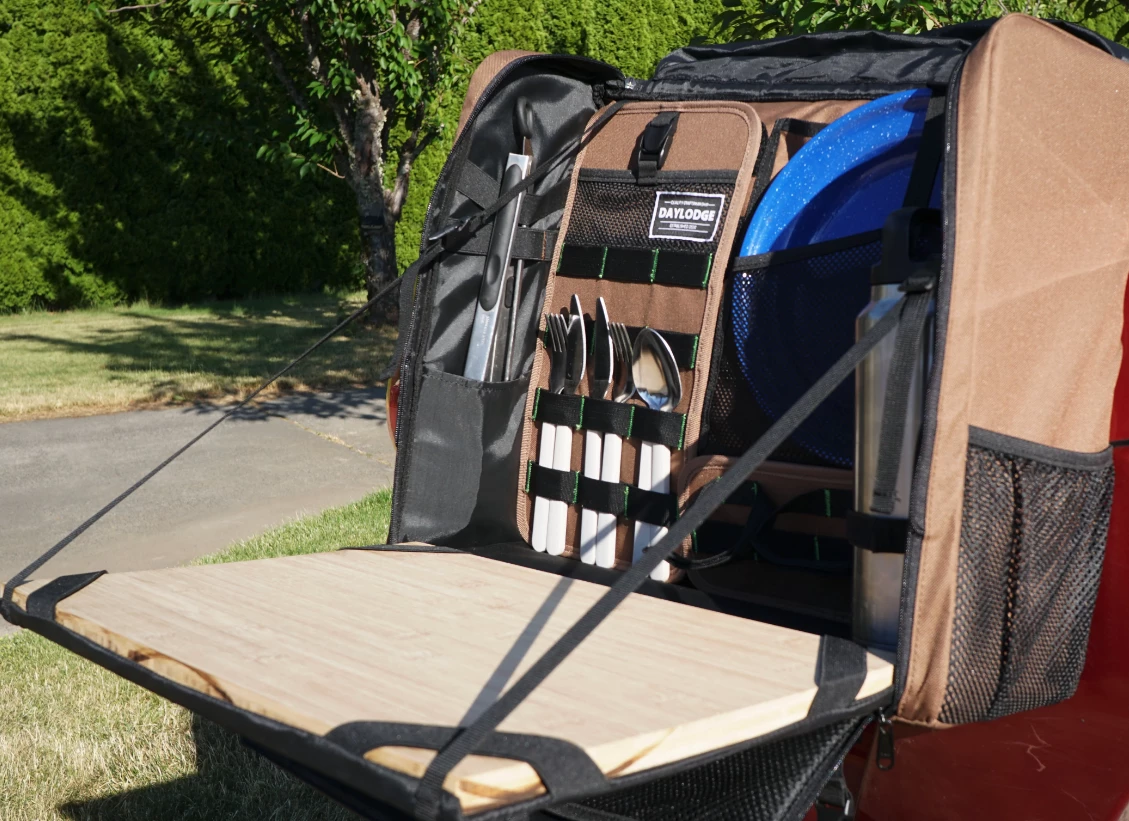 The Workspace travels like a bag, drops open into a kitchen workstation
