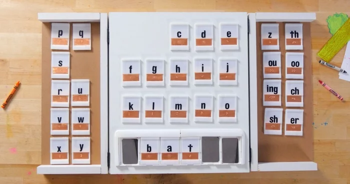 The word 'BAT' is spelled out and when the user runs their finger across the braille letters they hear the word phonetically spoken