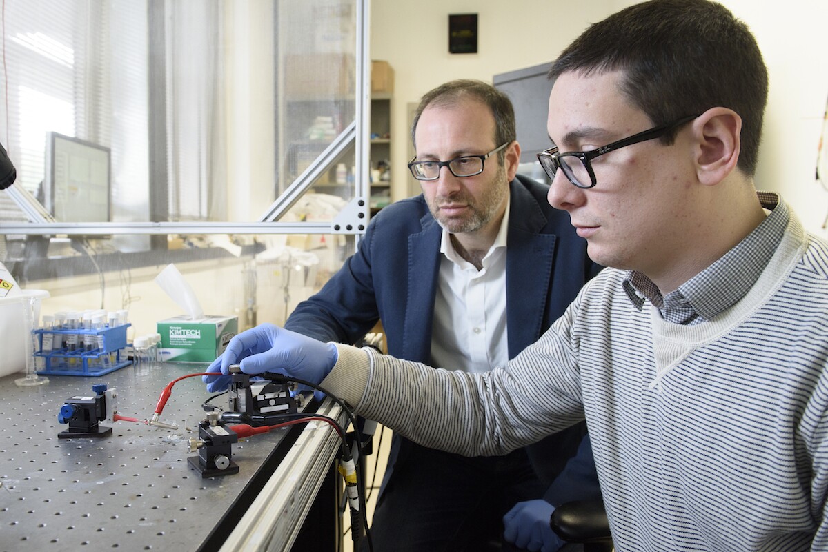 Alberto Salleo (left) and Scott Keene, two of the researchers on the project, test the artificial synapse