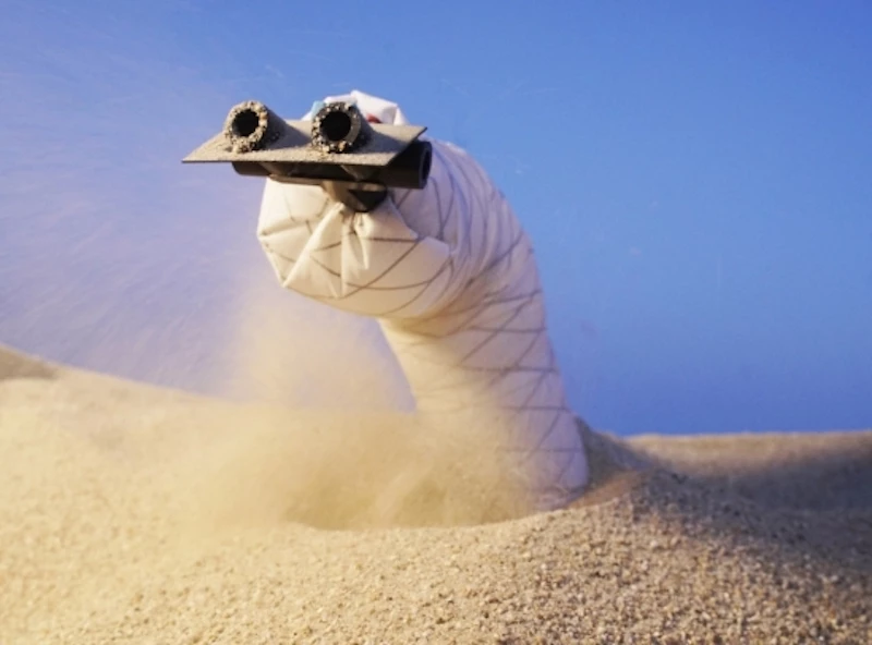 The new sand-burrowing robot has air jets in its front to blast sand out of its path, and a wedge-shaped head to help it steer
