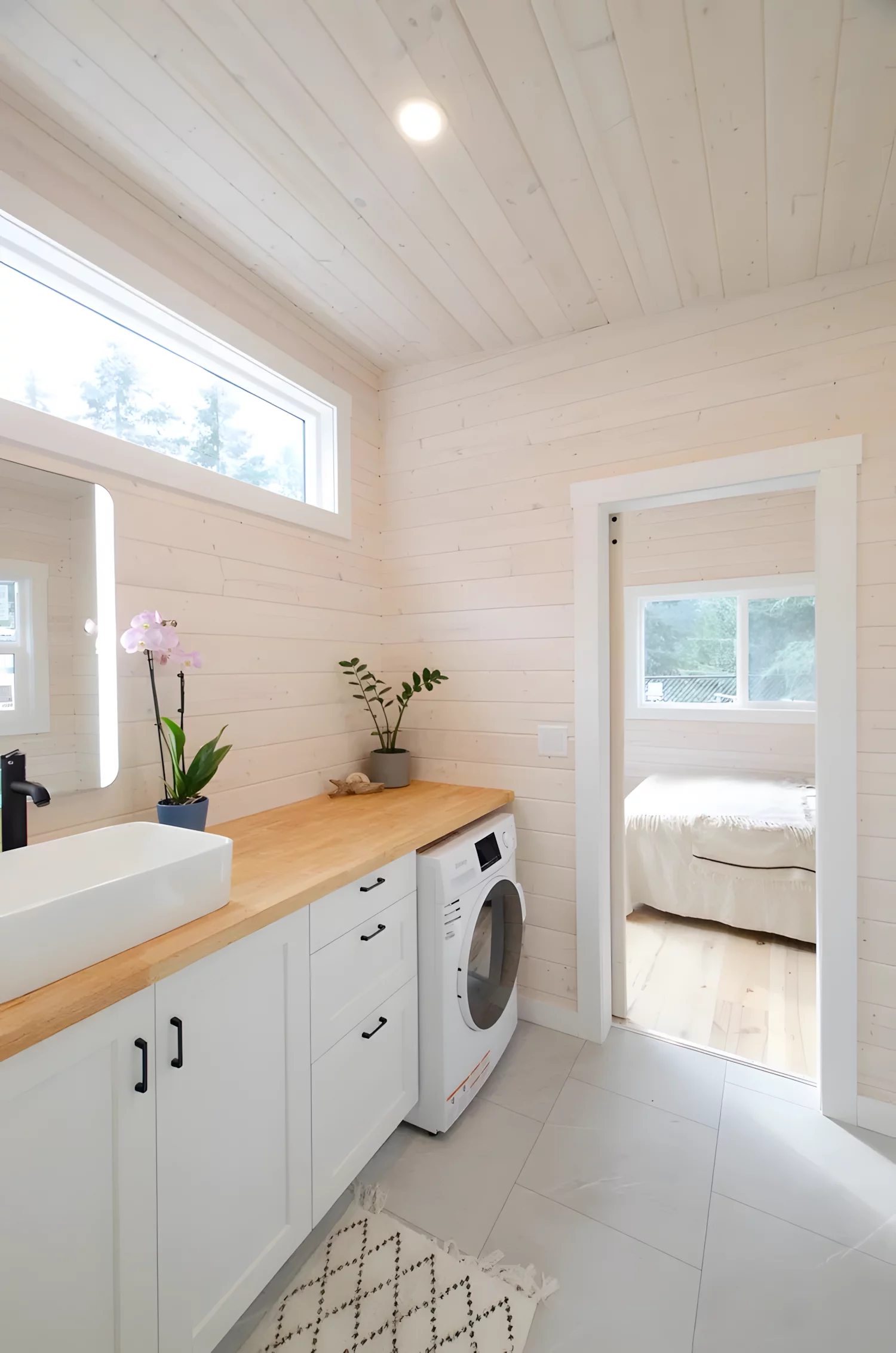 The Barred Owl's bathroom has a washer/dryer, along with some storage space