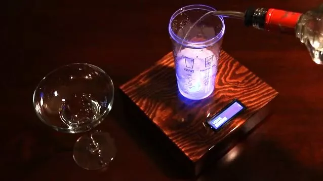 The Barman guides users through the drink-making process by weighing the added ingredients