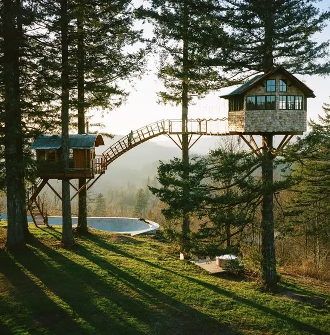 The Cinder Cone treehouse in Skamania County, Washington features a suspension bridge, and boasts both a full-size skate bowl and wood-fired hot tub