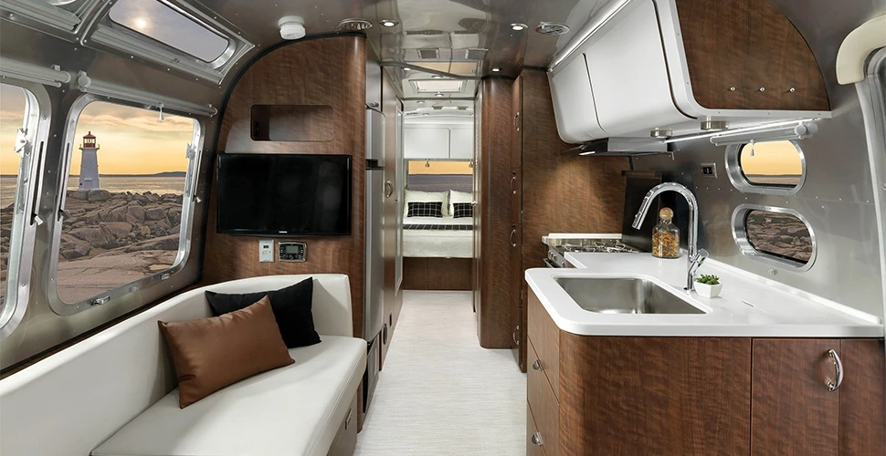 The Airstream Globetrotter's lounges pull out for extra bedding and are covered in finely woven, stain resistant fabric