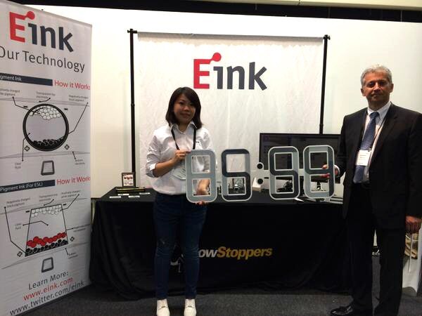 Zorah Lee (left) and Giovanni Mancini from E Ink holding a ClockONE at IFA 2014