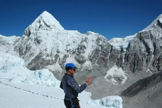 Dan Smith checks the weather on Everest