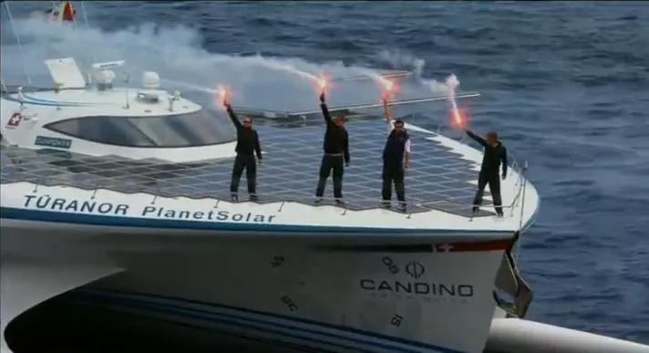 Crew members on the deck of the TURANOR PlanetSolar, as it enters Monaco's Hercule Harbor