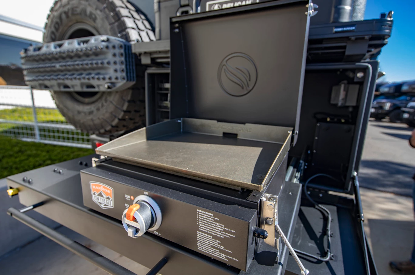 The available outdoor kitchen package includes buyer's choice of Solaire grill, Blackstone griddle or Traeger smoker