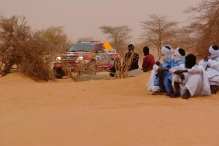 Mayer's Mitsubishi zips past the locals.