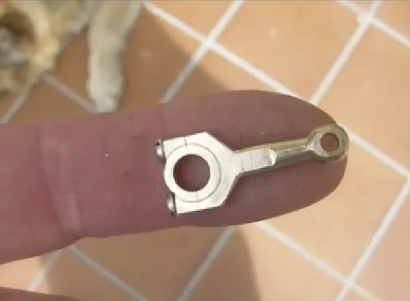 A tiny piston rod from Patelo's mini-V12 engine