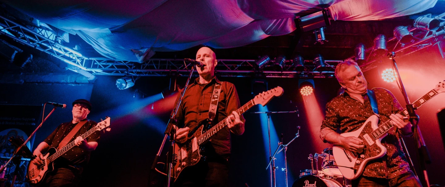 The author, center, with similarly offset bandmates, performing as Radio Radio