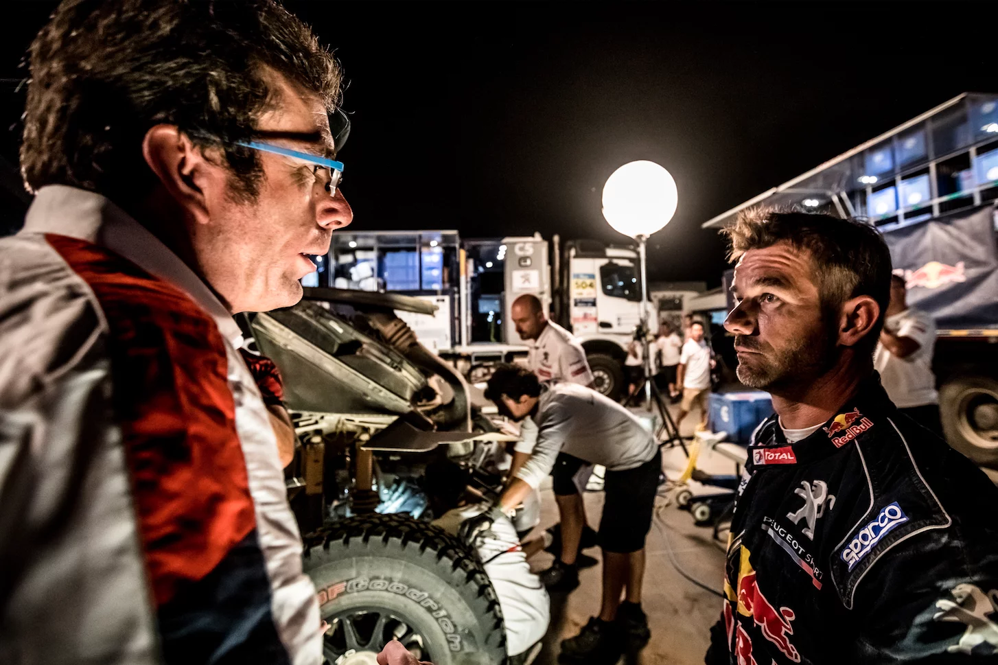 Sebastien Loeb in front of his battered Peugeot 3008DKR Maxi