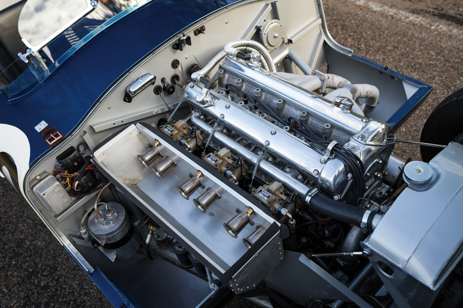 There were just 53 C-Type Jaguars built. Three lightweight works cars (of which this car is one), and a run of 50 cars to satisfy customer demand after the factory cars finished first, second and fourth in the 1953 Le Mans 24 Hour event. The biggest difference to the competition were the disc brakes. Endurance racing was born to demonstrate reliability and validate new automotive technologies for the masses and just as it has done more recently with hybrid and diesel drivetrains, Le Mans heralded the coming of age of a new braking technology with this car and its works siblings. The winning C-type was the first to average more than 100 mph for the 24 Hours of Le Mans (105.8 mph, 170 km/h), and this car, which finished fourth, also broke the ton, averaging 104 mph (167 km/h). Equally at home in any of the world’s finest concours or vintage rallies, this car represents a landmark in Jaguar history.
