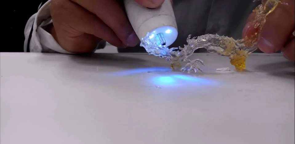 An artist sketches a dragon using the plastic polymer