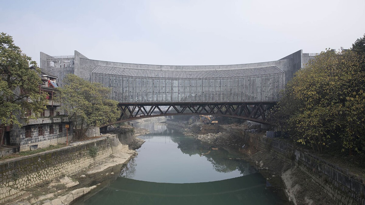 Jishou Art Museum straddles the Wanrong River and doubles as a pedestrian bridge