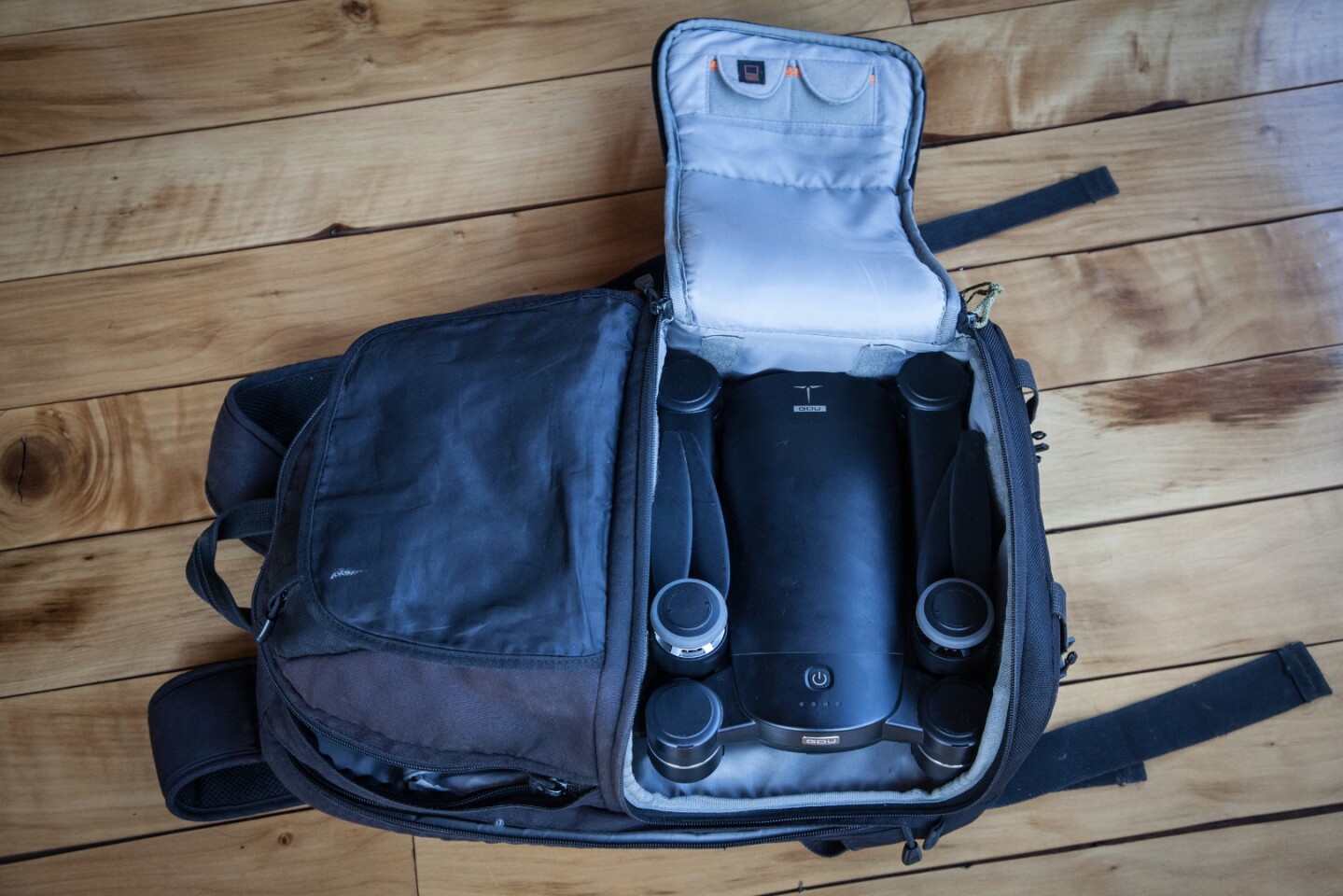 The folded drone body packed neatly inside a Lowepro camera bag