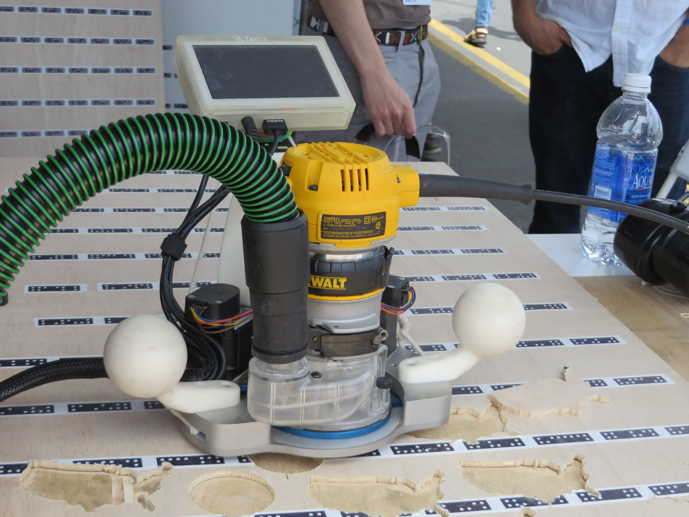 This computer aided router gives its human operator super-fine motor control for a perfect cut