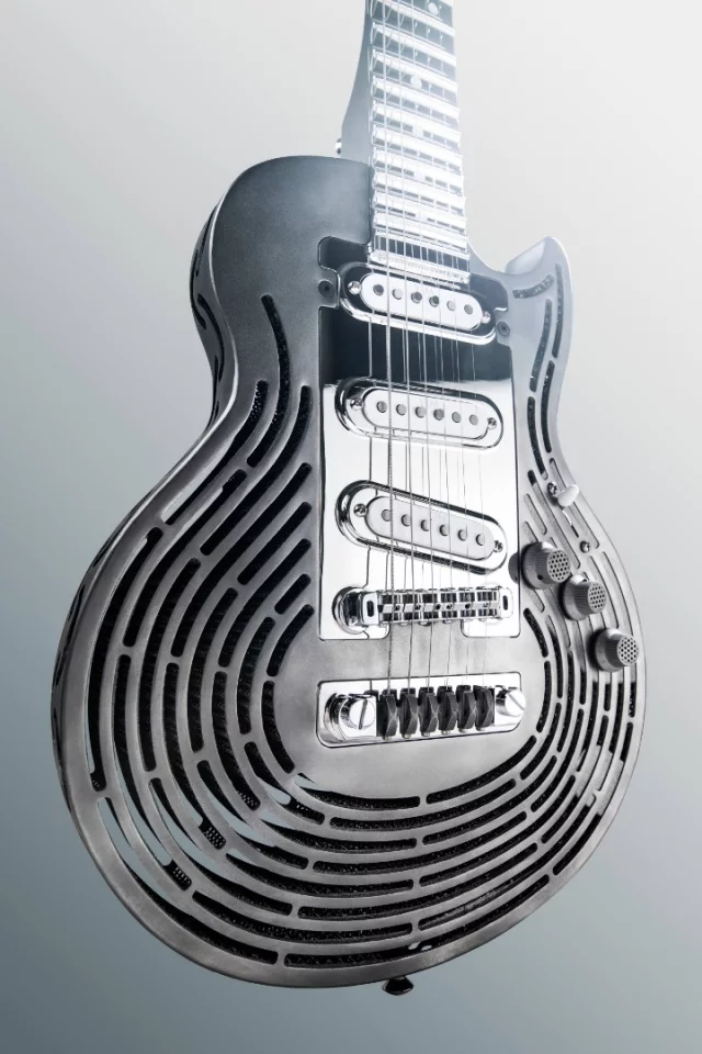 The roughly Les Paul-shaped titanium body of the Smash-Proof Guitar is 3D-printed