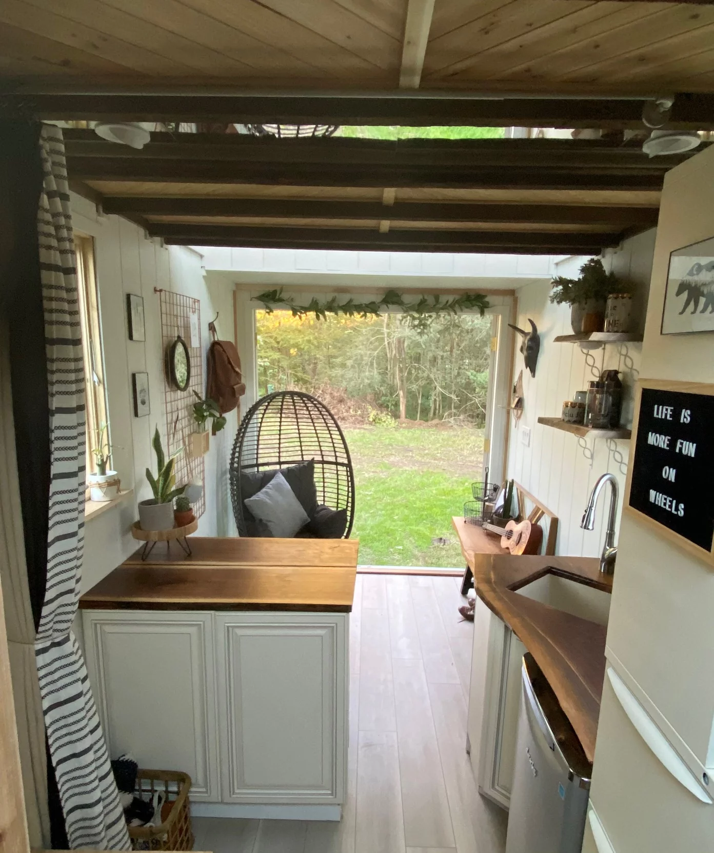 The interior floorplan incorporates a charming compact timber kitchen with in-built dining table for two