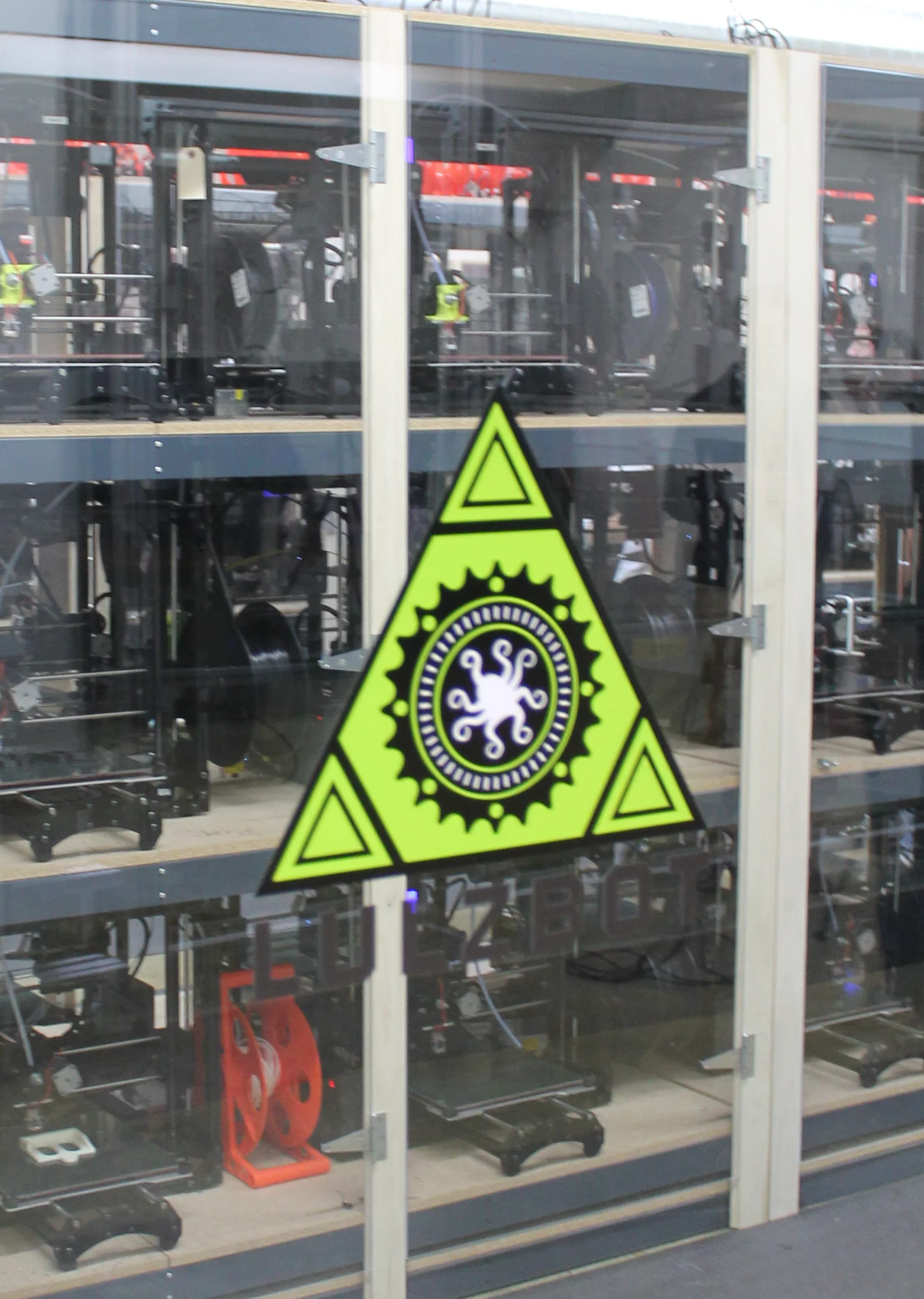 The LulzBot octopus logo frames the entrance to the 3D printer cluster at Aleph Objects, Inc. in Loveland, Colorado