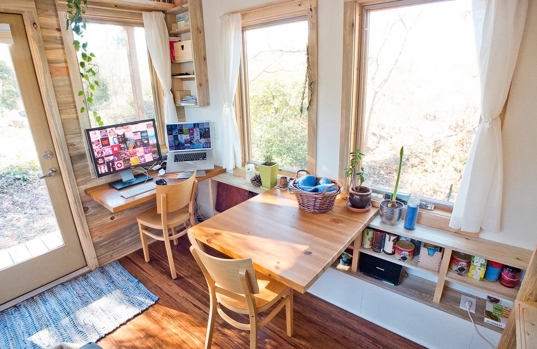 Space-saving furniture such as the foldable desk and dining table have been built into the home's structure