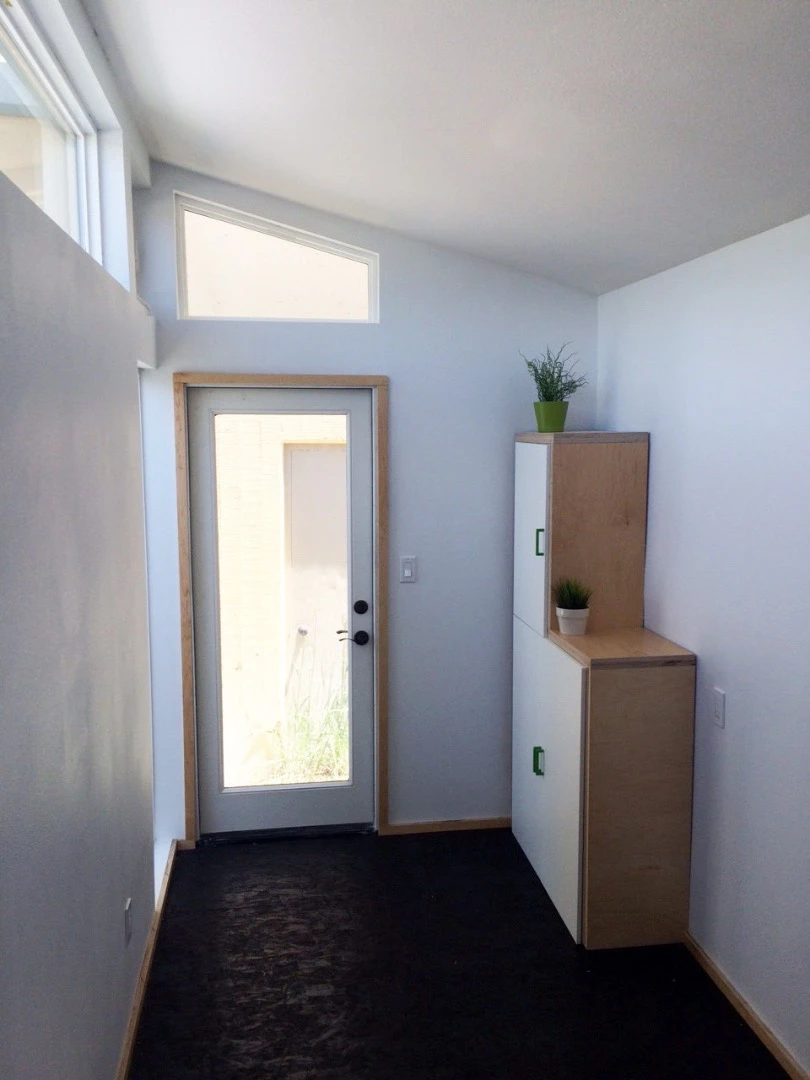 The interior of the shelter is open-plan and finished in white-painted drywall