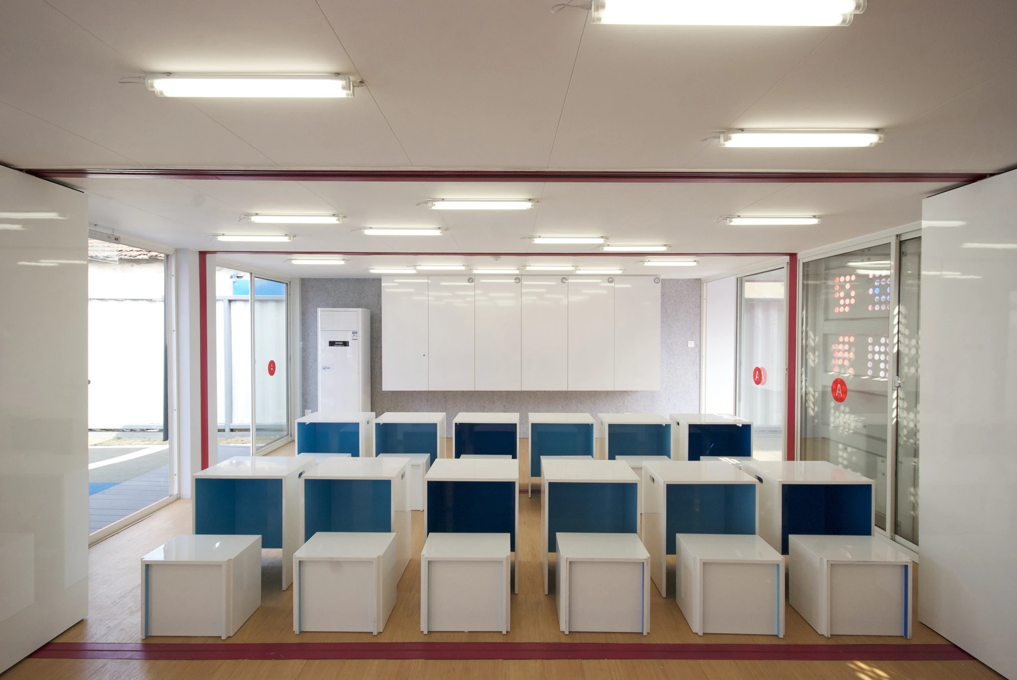 The room divider itself, the cabinets, and all suitable furniture sport a whiteboard finish for use as teaching surfaces (Photo: Jennifer Ha)
