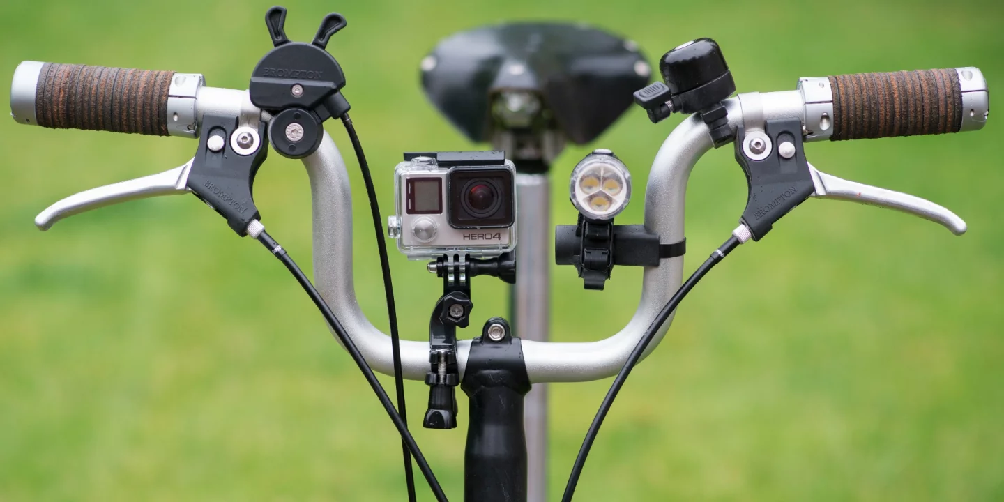 The GoPro Handlebar Mount consists of a clamp which fits around tubes of various sizes