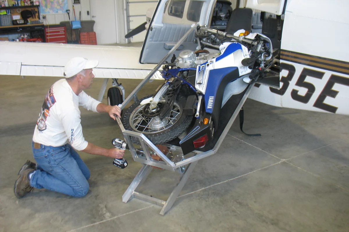 The MotoLOAD winches a MotoCYCLE into an airplane using a cordless drill