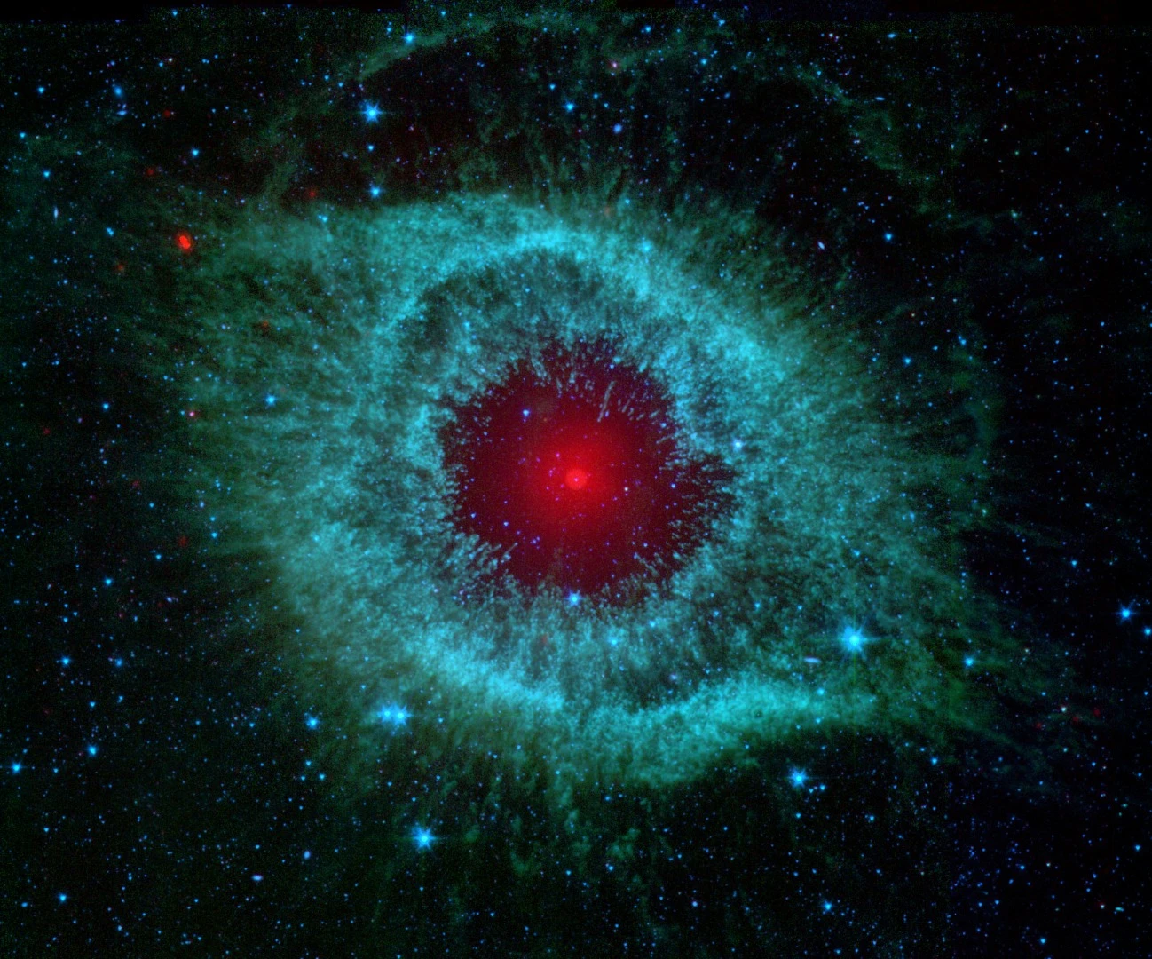 Just 700 light-years away, the eerie Helix Nebula keeps a close eye on Earth. At the center of a two-light-year-wide cloud of gas, the white dwarf star glows a creepy red thanks to a dusty disk of debris, possibly formed by a cluster of comet-like bodies constantly colliding.