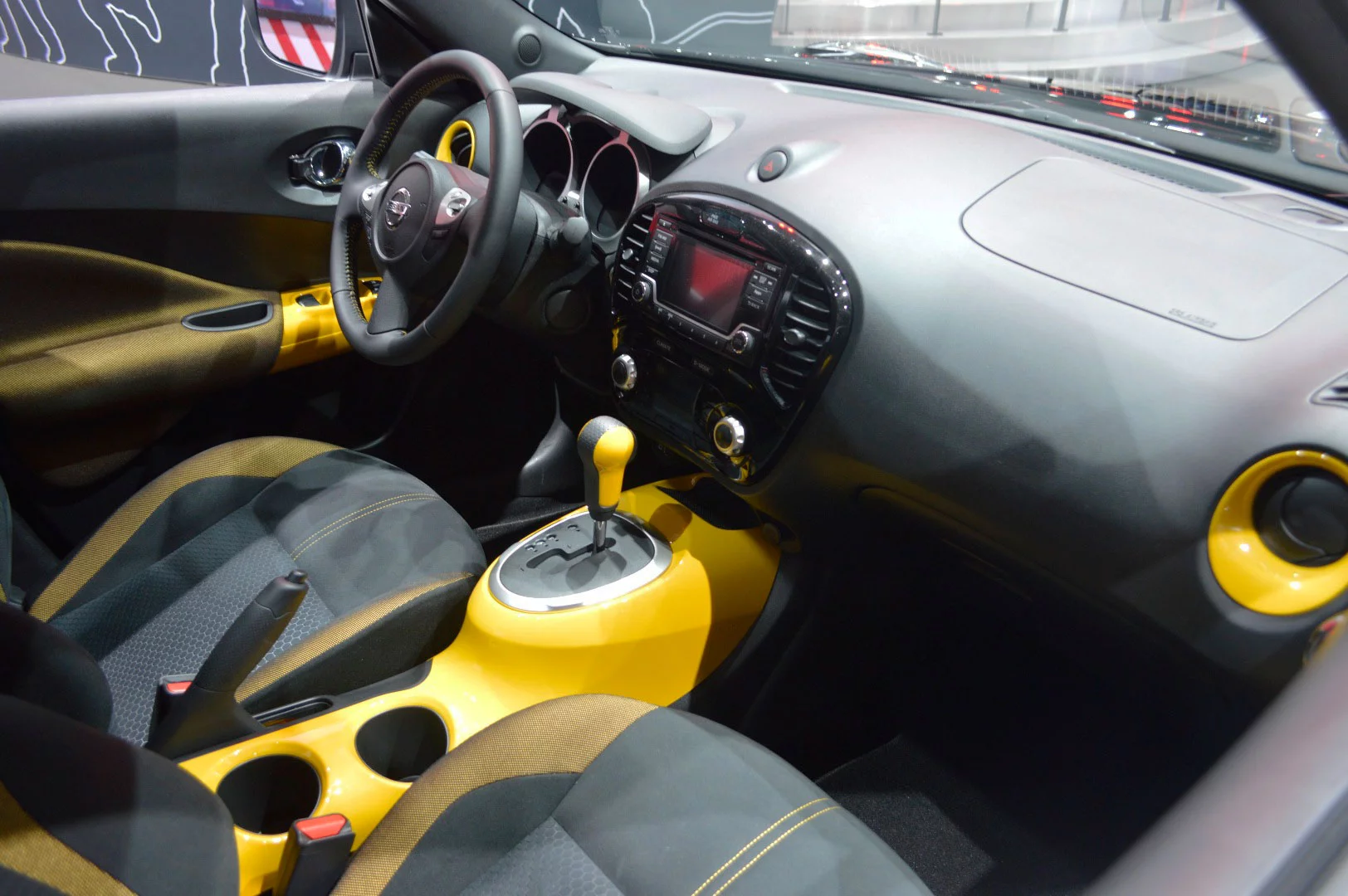 Inside, yellow adorns the center console, power window switch plates, air vent rings, and more