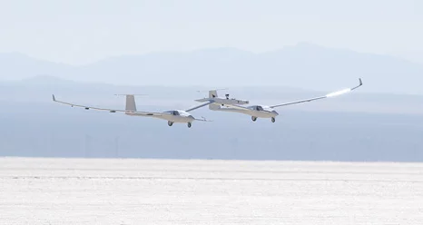 The one-third scale twin-fuselage towed glider glides in for landing on Rogers Dry Lake after its successful first test flight (Photo: NASA / Tom Tschida)