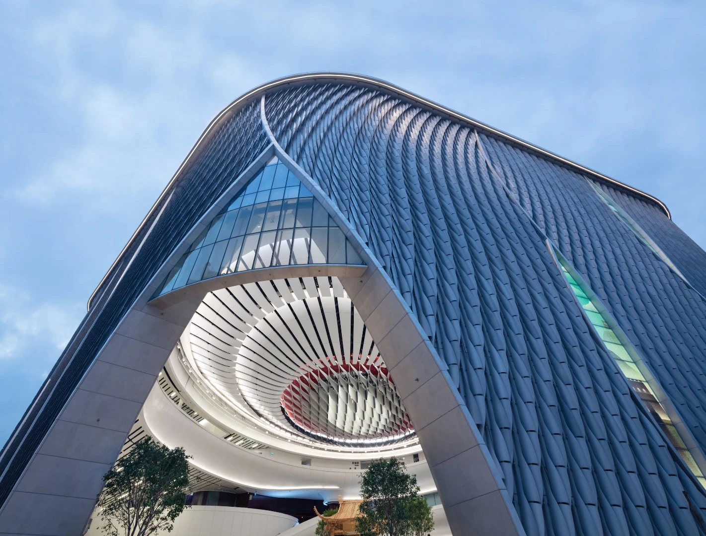 The Xiqu Centre's facade comprises a modular system of scaled aluminum that was CNC (computer numerically controlled) cut from untreated marine-grade piping