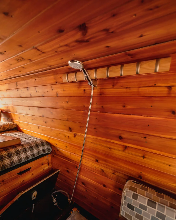 One of the Golden Egg's more interesting tricks — the shower is concealed in the bed steps, popping out for a makeshift shower area and disappearing away to open up space as compared to a full-time bathroom cell