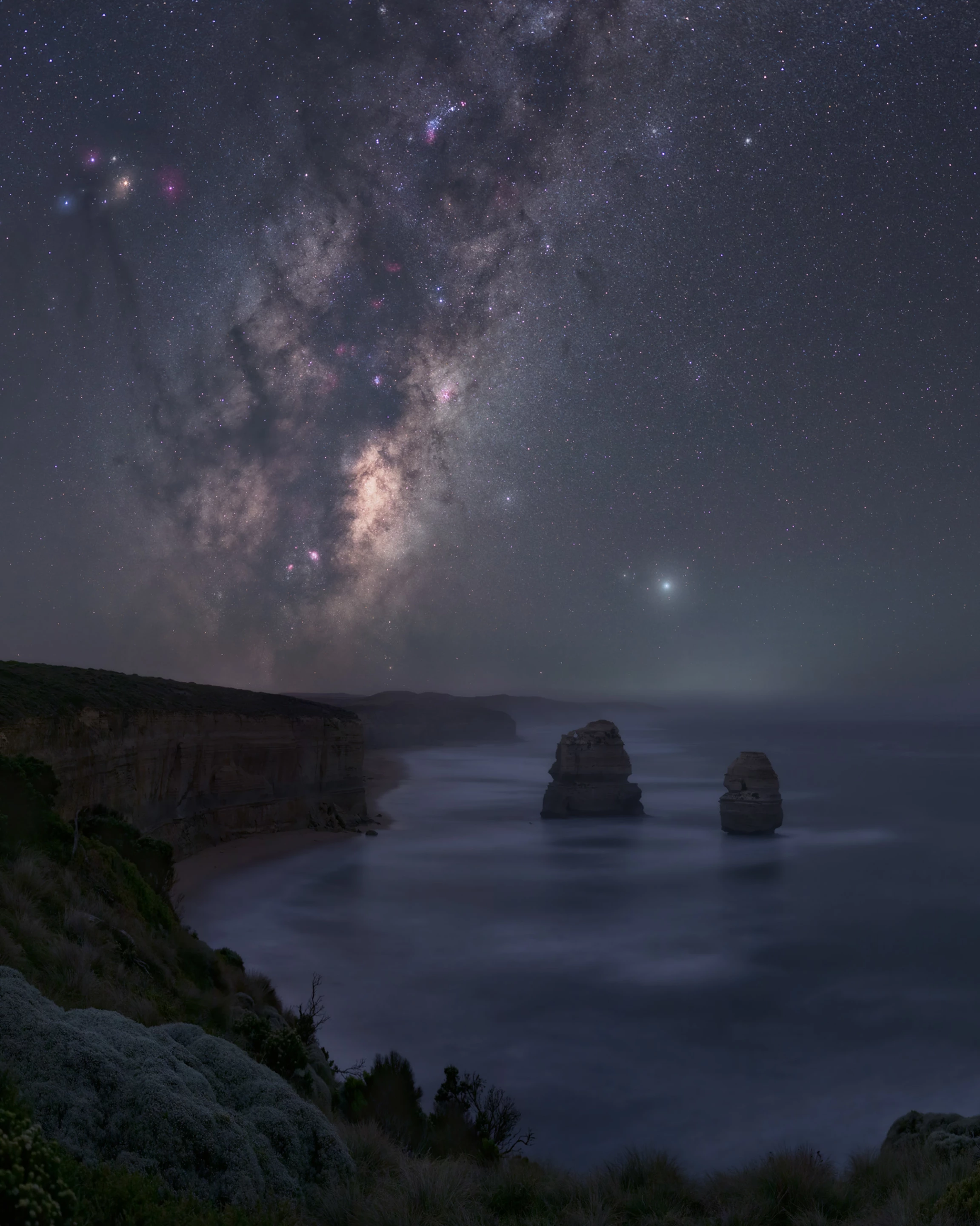 Nyctophilia, taken on the Great Ocean Road in Victoria, Australia. The craggy coastline curves off into the darkness under the watchful eye of the Milky Way