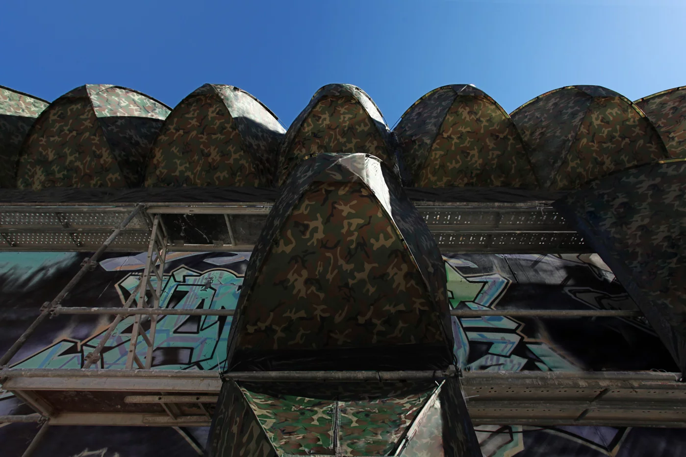 This installation, called Stealth Shelters, sits between public and private property suggesting an in-between liminal space where those without a home to go to could find a safe place at night